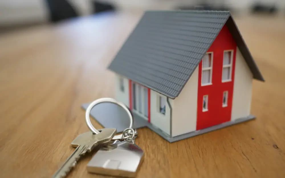 Model home and keys representing real estate